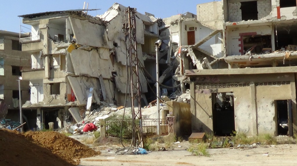 Destroyed buildings surround the main square in Harasta which demonstrators nicknamed Freedom Square - Photography by Razan Zeitouneh