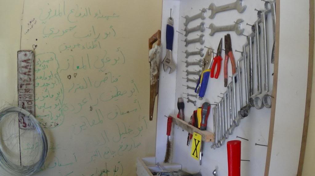 The workshop where fire extinguishers are made. Martyrs' names are written on the wall - Photography by Razan Zeitouneh