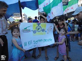 A banner held during a demonstration in Homs late August. Credit: "Lens Young Homsi" page on Facebook